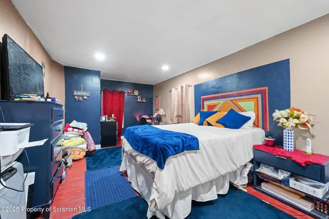 a bathroom with a sink a toilet a window and shower