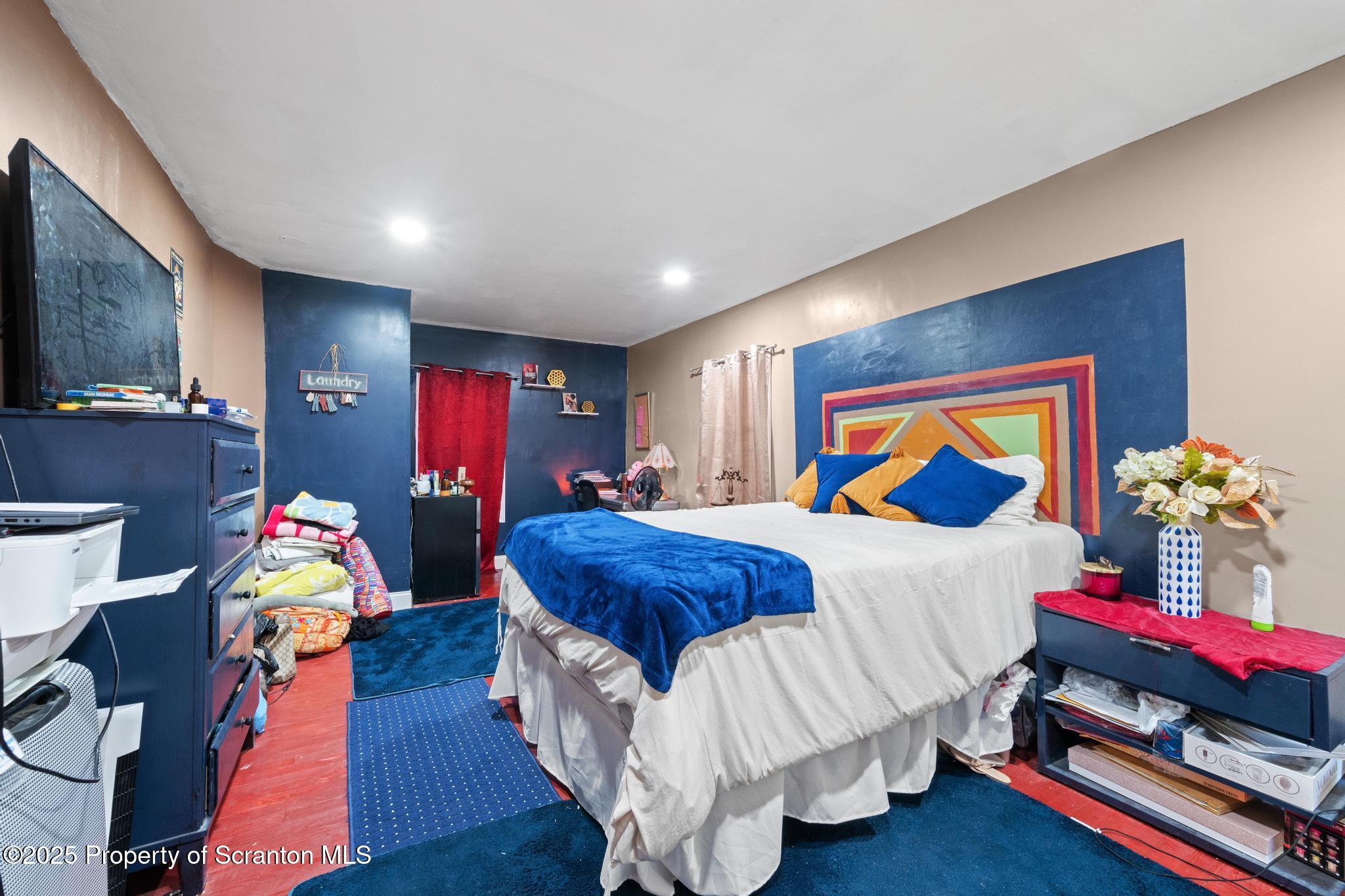 70 State Street Nicholson, PA 18446 - Photo 36 of 64 a bed room with bed and paintings on the wall