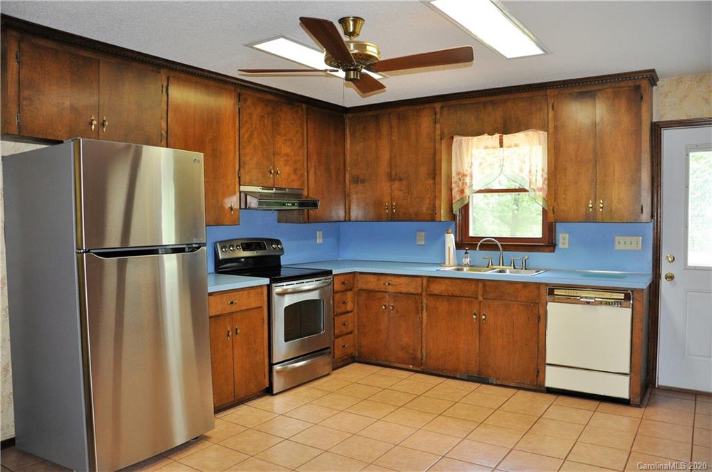 280 Bennett Road Rutherfordton, NC 28139 - Photo 7 of 44 a kitchen with stainless steel appliances granite countertop a refrigerator sink and cabinets