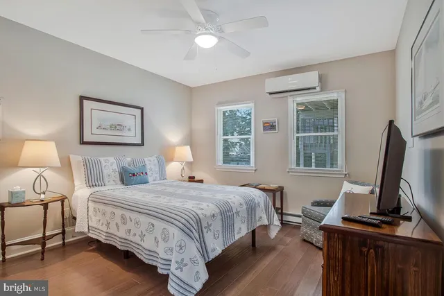 a bedroom with a bed desk and a window