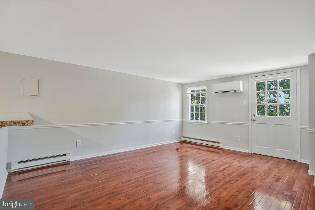 320 Chester Avenue Annapolis, MD 21403 - Photo 19 of 32 an empty room with wooden floor and windows