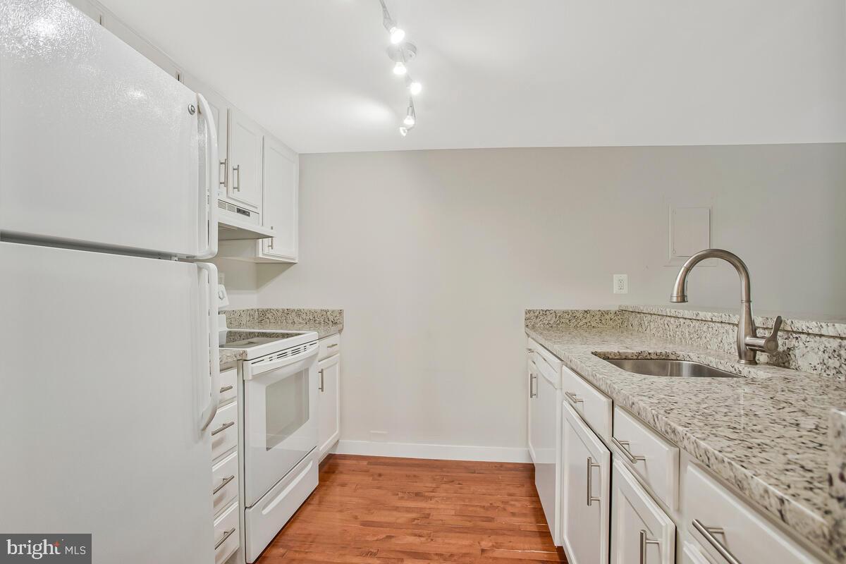 320 Chester Avenue Annapolis, MD 21403 - Photo 23 of 32 a kitchen with stainless steel appliances granite countertop a sink and a refrigerator