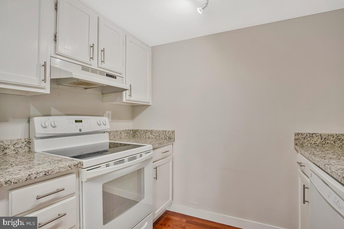 320 Chester Avenue Annapolis, MD 21403 - Photo 25 of 32 a kitchen with granite countertop white cabinets and white appliances
