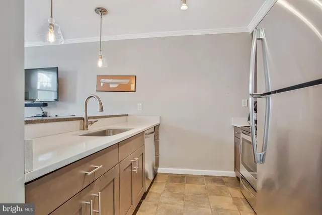 a kitchen with a sink a refrigerator a washer and dryer