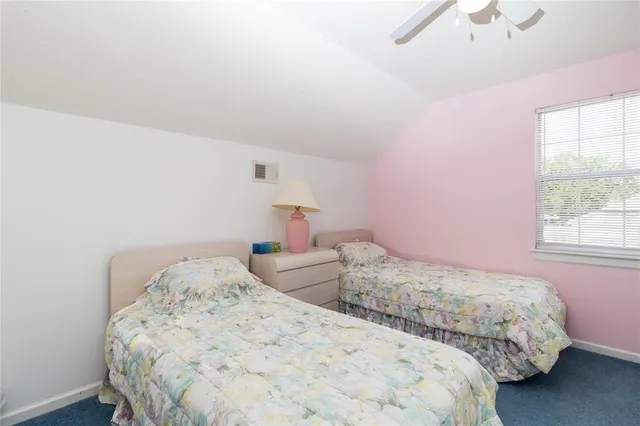 a bedroom with two beds and a window