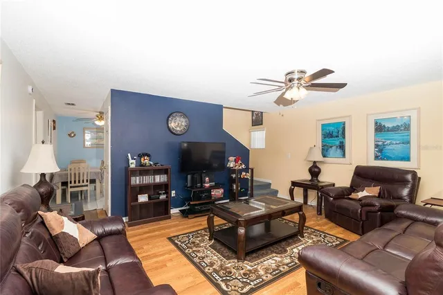 a living room with furniture a rug and a window