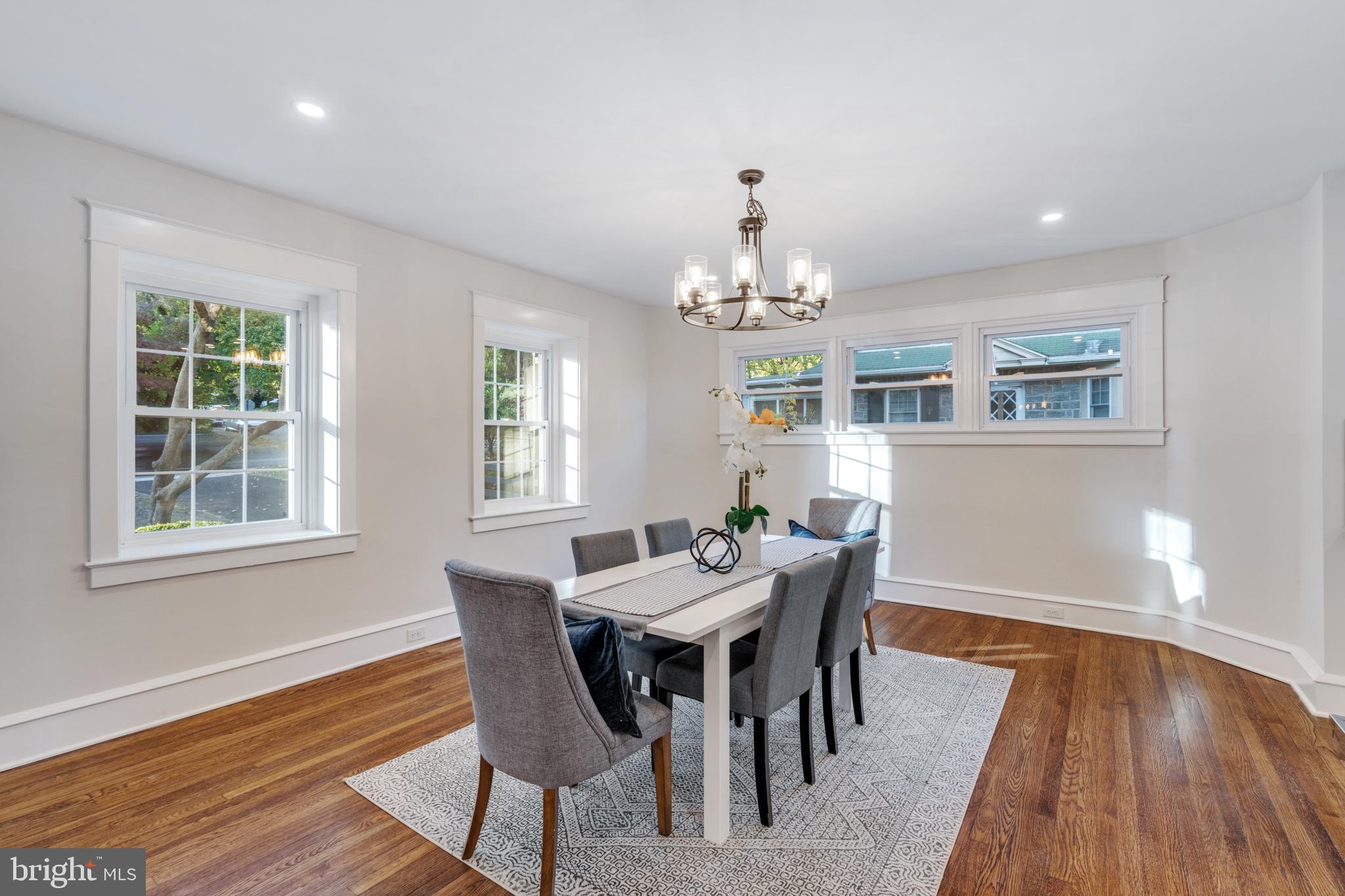 39 North Rolling Road Springfield, PA 19064 - Photo 28 of 119 a view of a dining room with furniture a chandelier and wooden floor