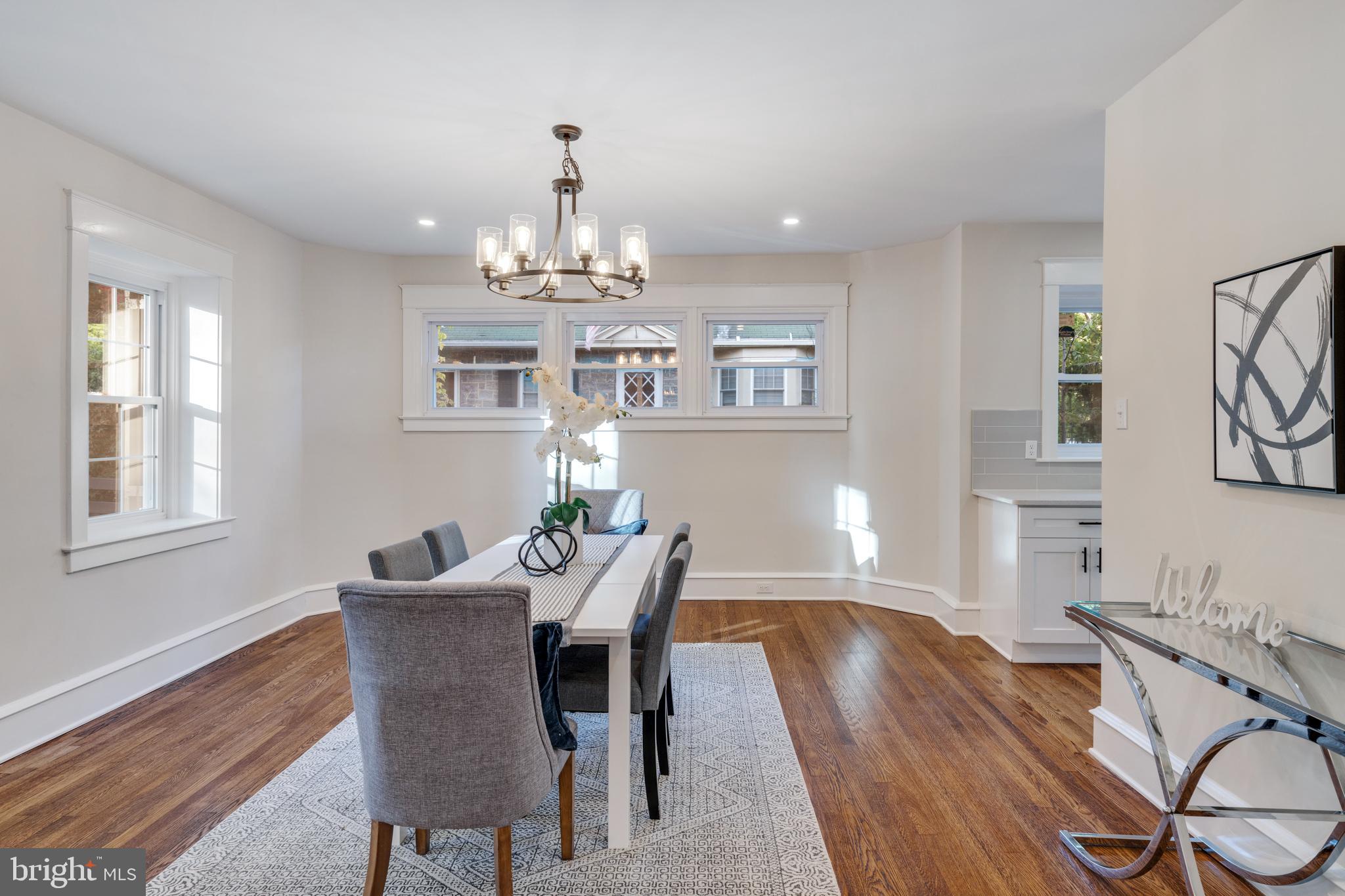 39 North Rolling Road Springfield, PA 19064 - Photo 29 of 119 a view of a dining room with furniture a chandelier and wooden floor