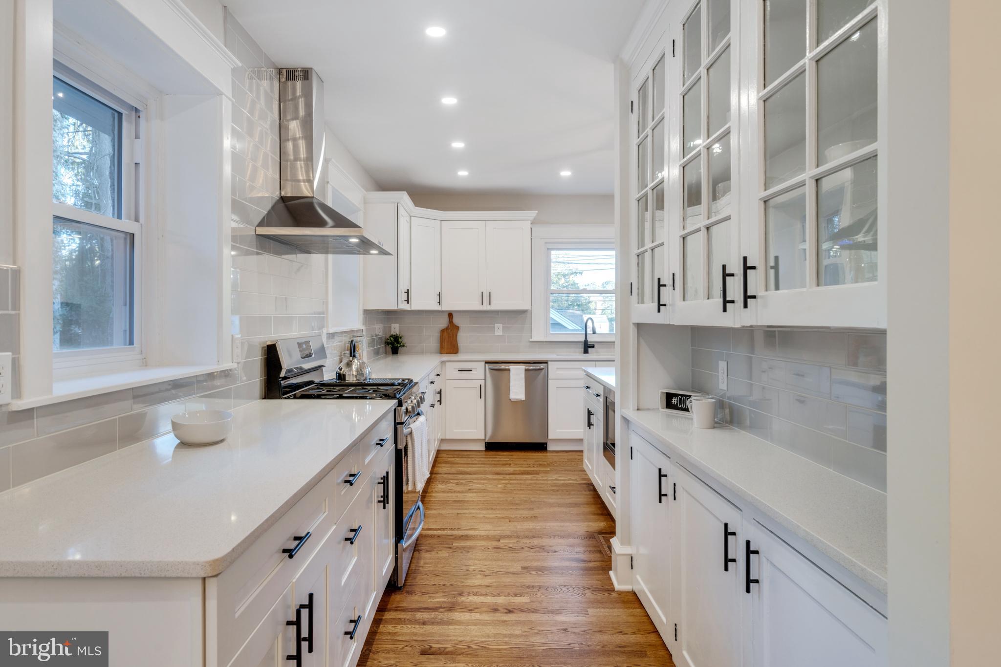 39 North Rolling Road Springfield, PA 19064 - Photo 32 of 119 a kitchen with kitchen island granite countertop lots of white stainless steel appliances cabinets and a sink