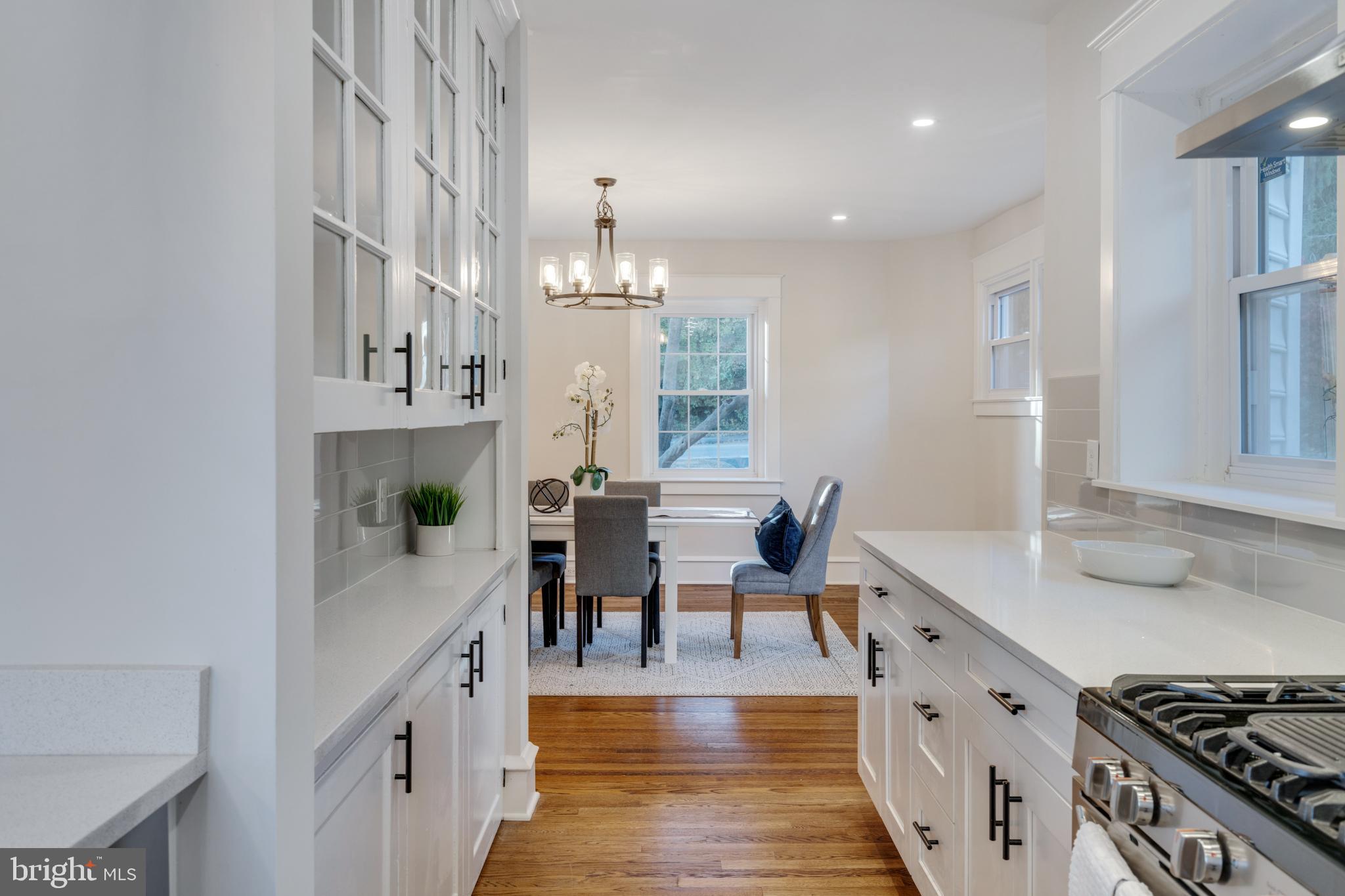39 North Rolling Road Springfield, PA 19064 - Photo 33 of 119 a kitchen with stainless steel appliances a table and chairs in it