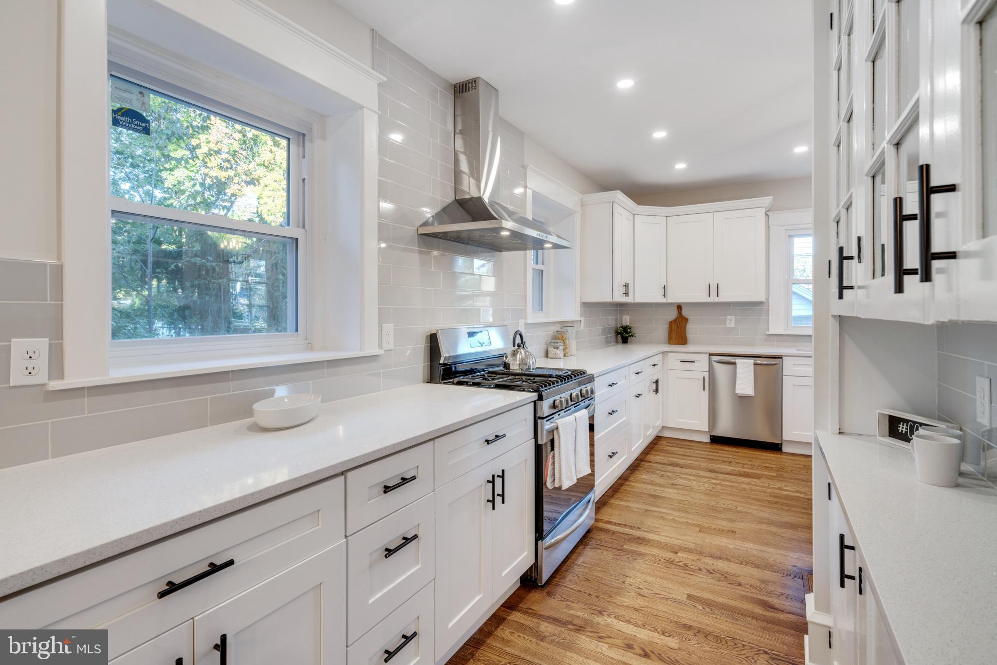 39 North Rolling Road Springfield, PA 19064 - Photo 34 of 119 a large kitchen with stainless steel appliances granite countertop a lot of counter space and wooden floors