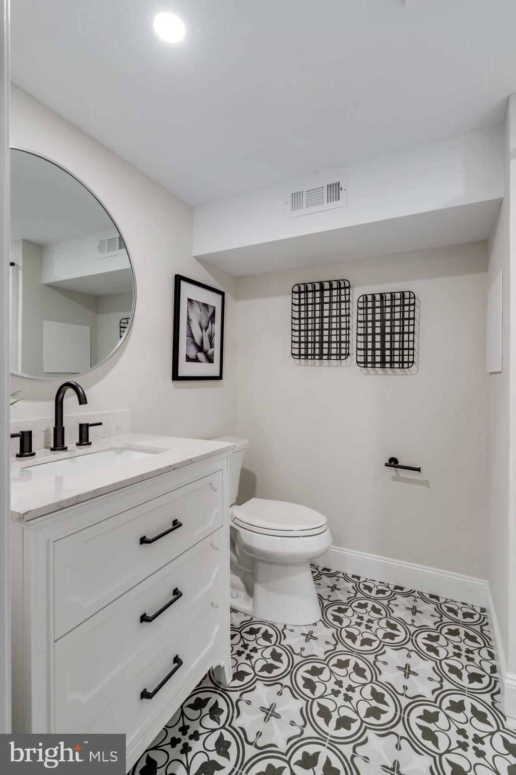 39 North Rolling Road Springfield, PA 19064 - Photo 89 of 119 a bathroom with a sink a toilet and a mirror