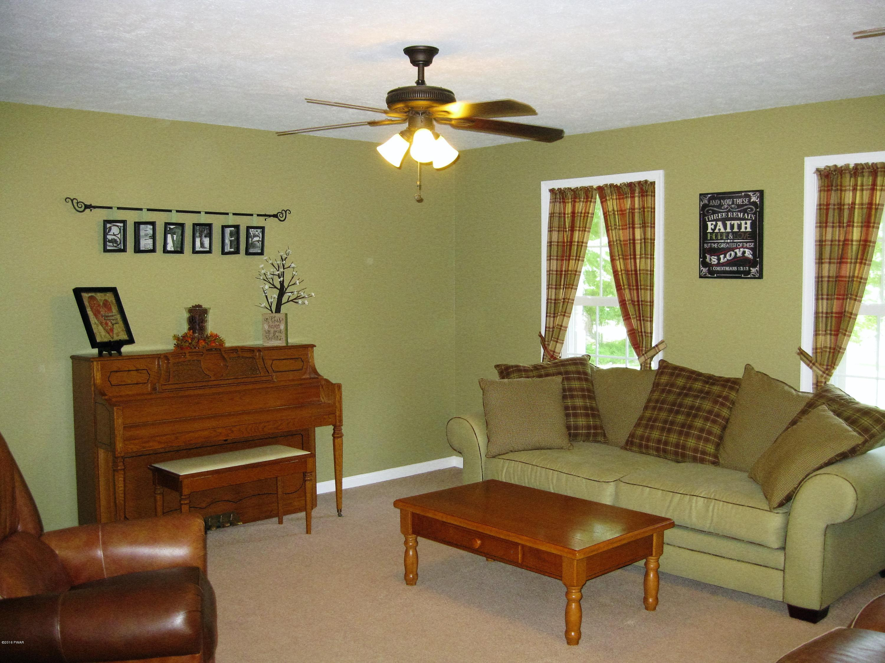 137 Caribou Road Dingmans Ferry, PA 18328 - Photo 9 of 34 a living room with furniture and a window