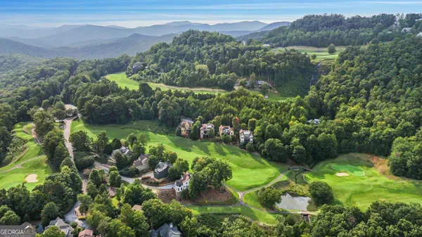 an aerial view of a house with a yard basket ball court and outdoor seating