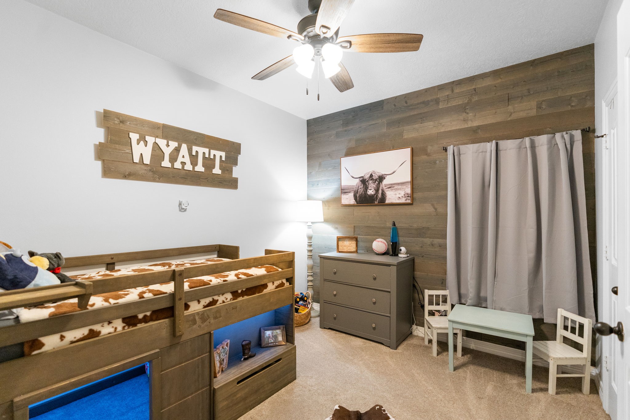 5942 Wildflower Road Sealy, TX 77474 - Photo 18 of 41 a bedroom with a bed and a chandelier