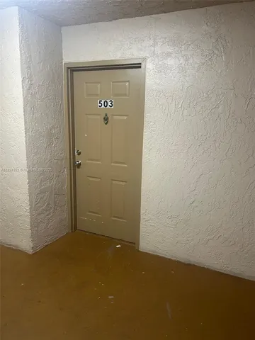 a kitchen with a refrigerator and a sink