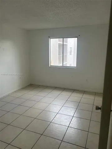 a view of a livingroom with an empty space and a window