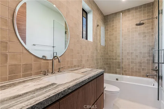 a living room with furniture and a view of kitchen