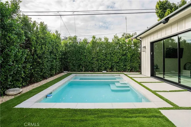 a view of swimming pool with seating area