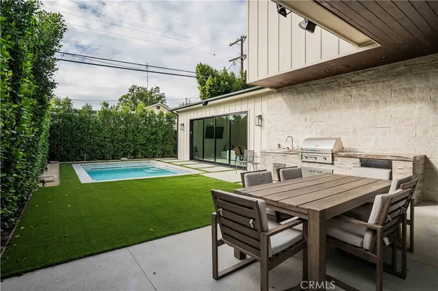 a kitchen with a stove and white cabinets