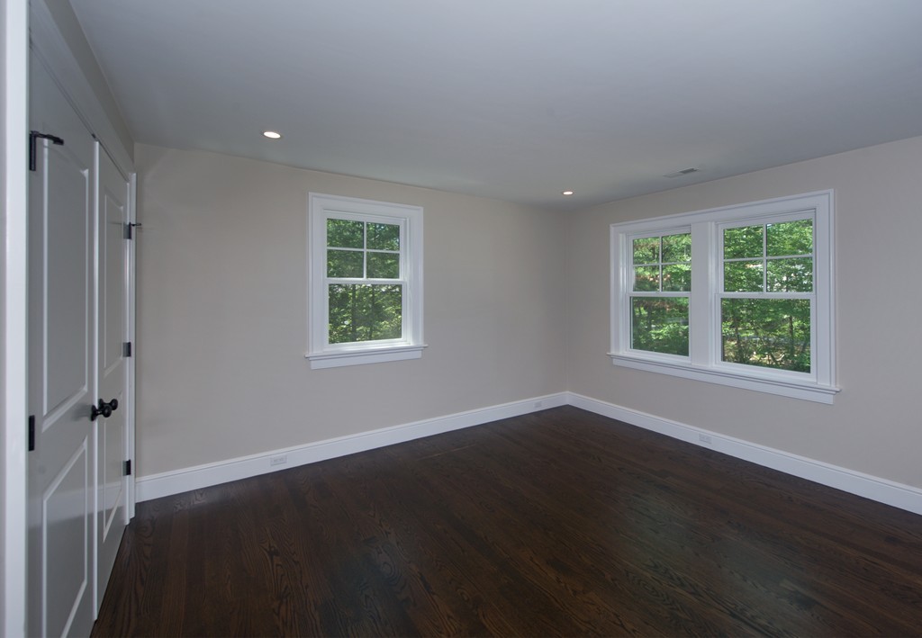 77 Autumn Road Weston, MA 02493 - Photo 20 of 24 an empty room with wooden floor and windows