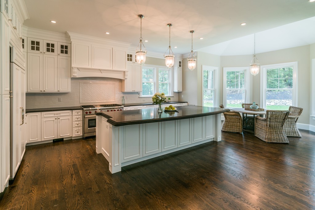 77 Autumn Road Weston, MA 02493 - Photo 7 of 24 a kitchen with stainless steel appliances granite countertop wooden floors and white cabinets