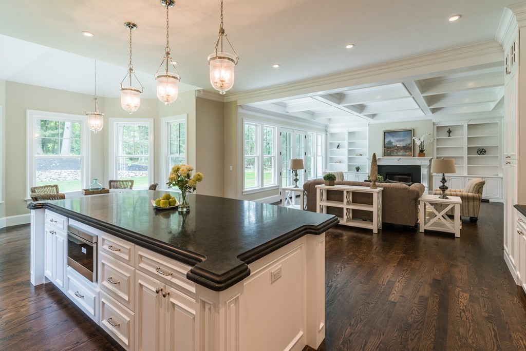 77 Autumn Road Weston, MA 02493 - Photo 8 of 24 a kitchen with stainless steel appliances granite countertop a stove a sink dishwasher a dining table and chairs with wooden floor