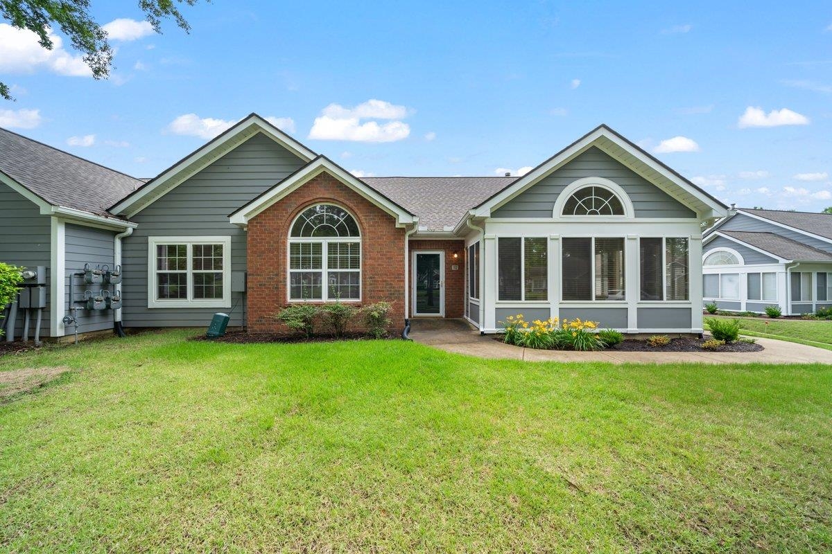 a front view of a house with a garden
