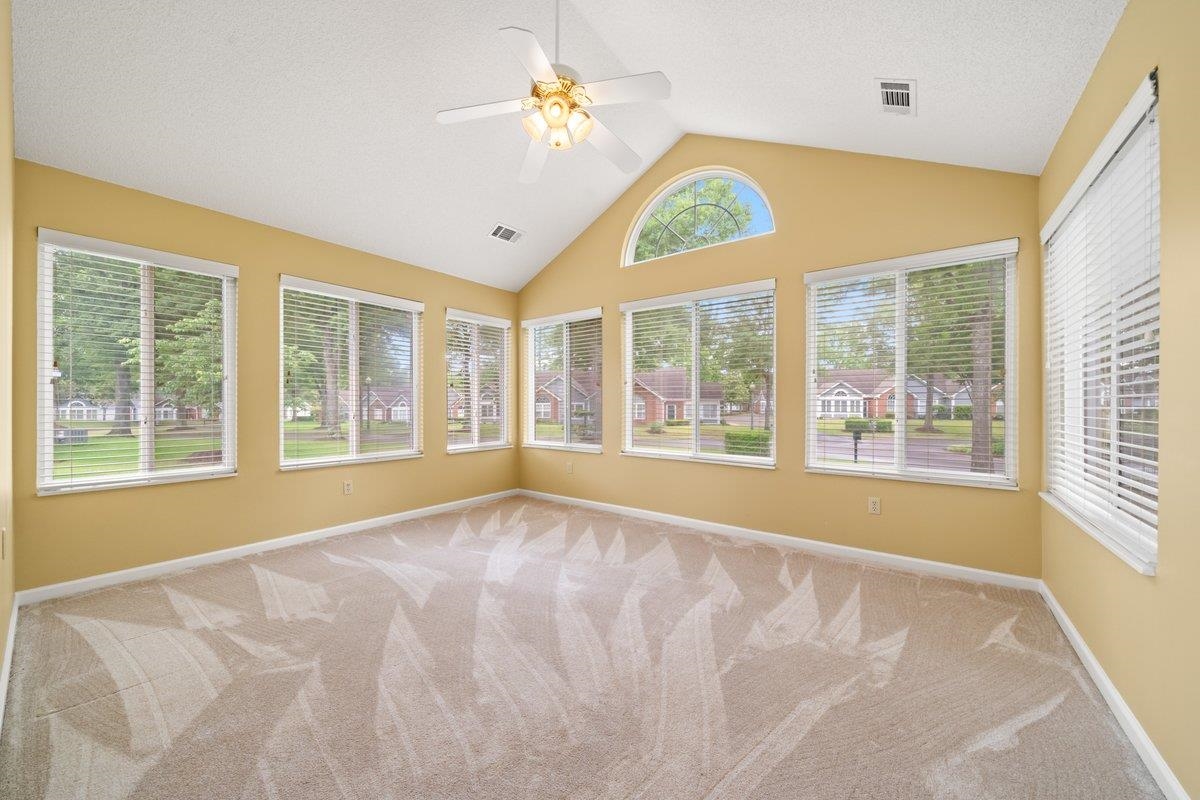 1102 Oak Heights Lane, Unit 93 Collierville, TN 38017 - Photo 12 of 30 a view of an empty room with a window and a ceiling fan
