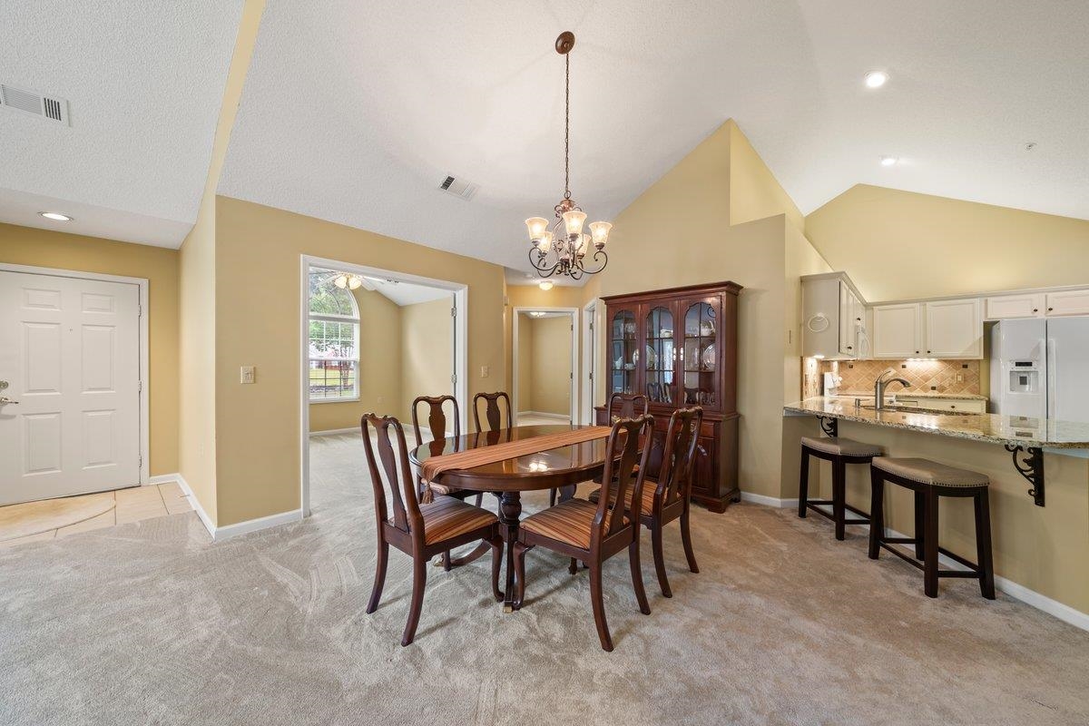 1102 Oak Heights Lane, Unit 93 Collierville, TN 38017 - Photo 13 of 30 a view of a dining room with furniture and chandelier