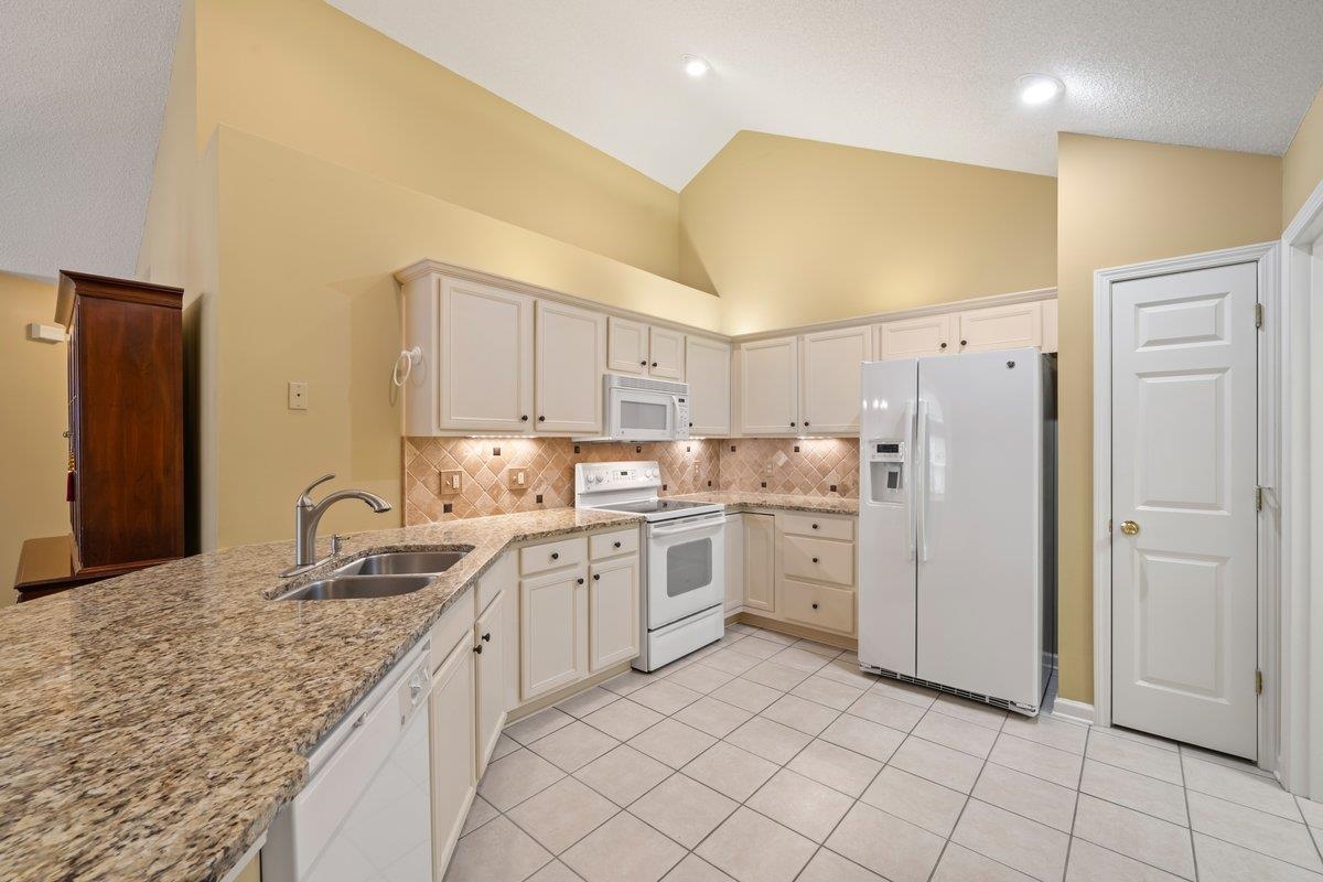 1102 Oak Heights Lane, Unit 93 Collierville, TN 38017 - Photo 17 of 30 a kitchen with white cabinets and appliances