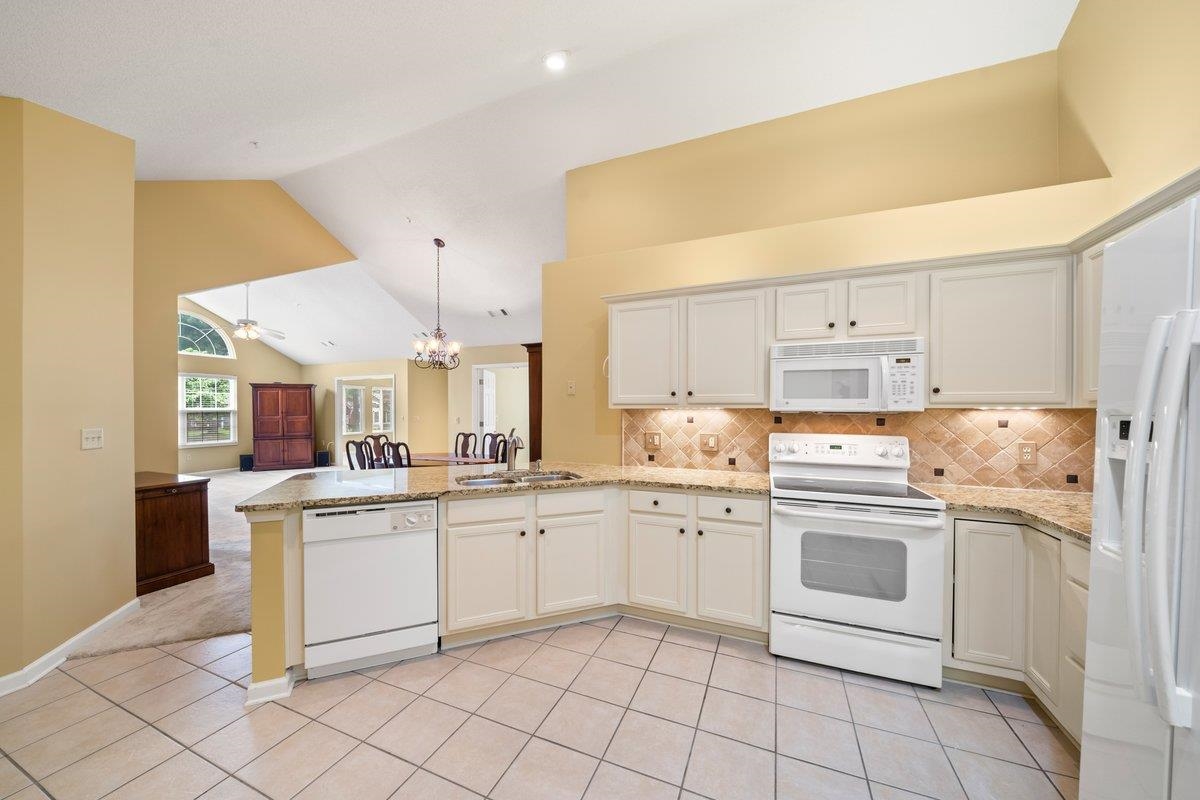 1102 Oak Heights Lane, Unit 93 Collierville, TN 38017 - Photo 18 of 30 a kitchen with white cabinets and white appliances