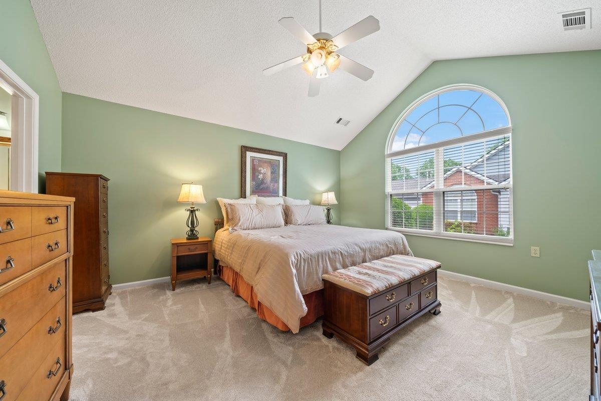 1102 Oak Heights Lane, Unit 93 Collierville, TN 38017 - Photo 19 of 30 a spacious bedroom with a bed and a chandelier