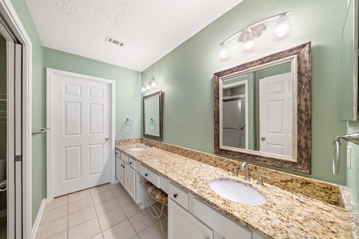 1102 Oak Heights Lane, Unit 93 Collierville, TN 38017 - Photo 20 of 30 a spacious bathroom with a granite countertop double vanity sink a mirror and a