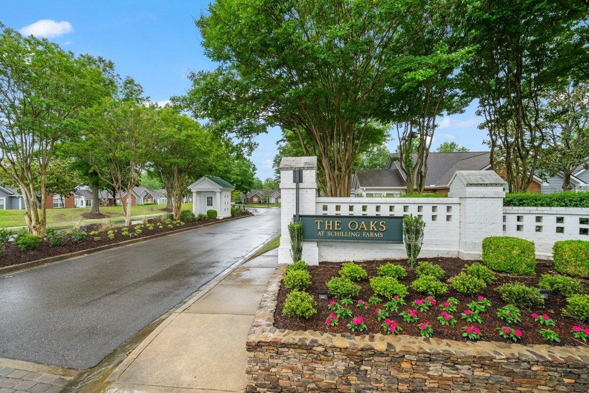 1102 Oak Heights Lane, Unit 93 Collierville, TN 38017 - Photo 2 of 30 a street sign on a sidewalk next to a road