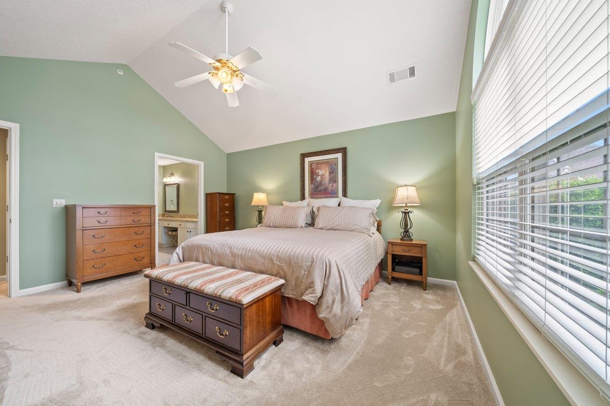 1102 Oak Heights Lane, Unit 93 Collierville, TN 38017 - Photo 22 of 30 a spacious bedroom with a bed and a chandelier