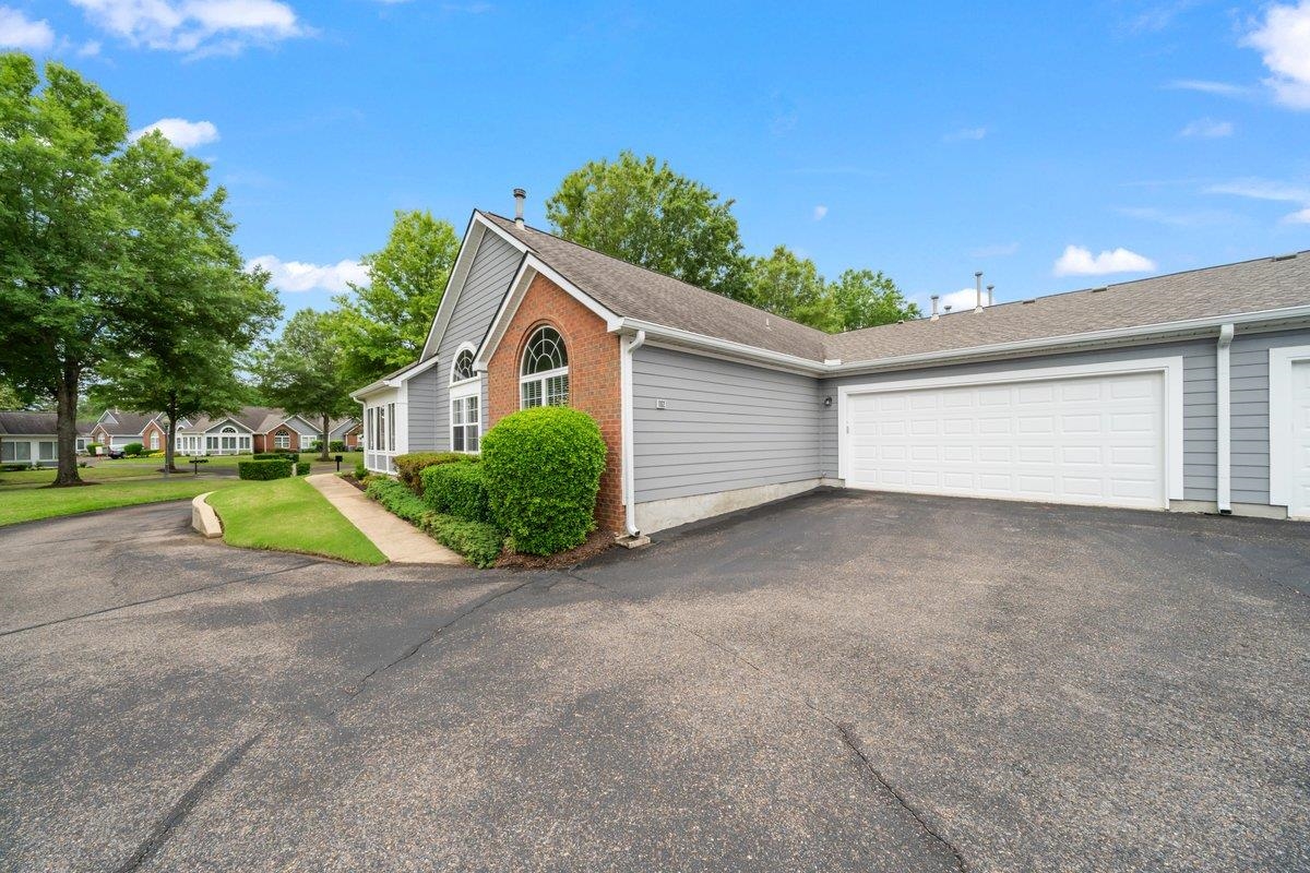 1102 Oak Heights Lane, Unit 93 Collierville, TN 38017 - Photo 6 of 30 a view of backyard and tree