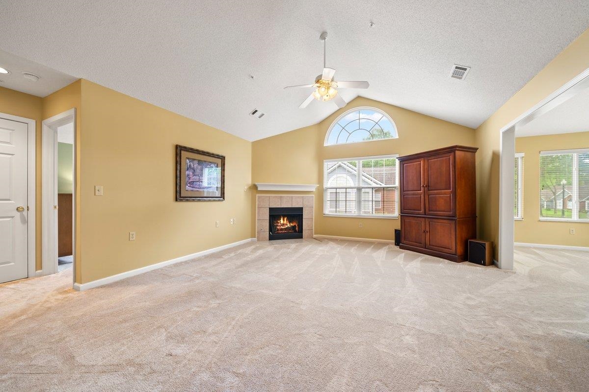 1102 Oak Heights Lane, Unit 93 Collierville, TN 38017 - Photo 8 of 30 an empty room with a fireplace and a ceiling fan
