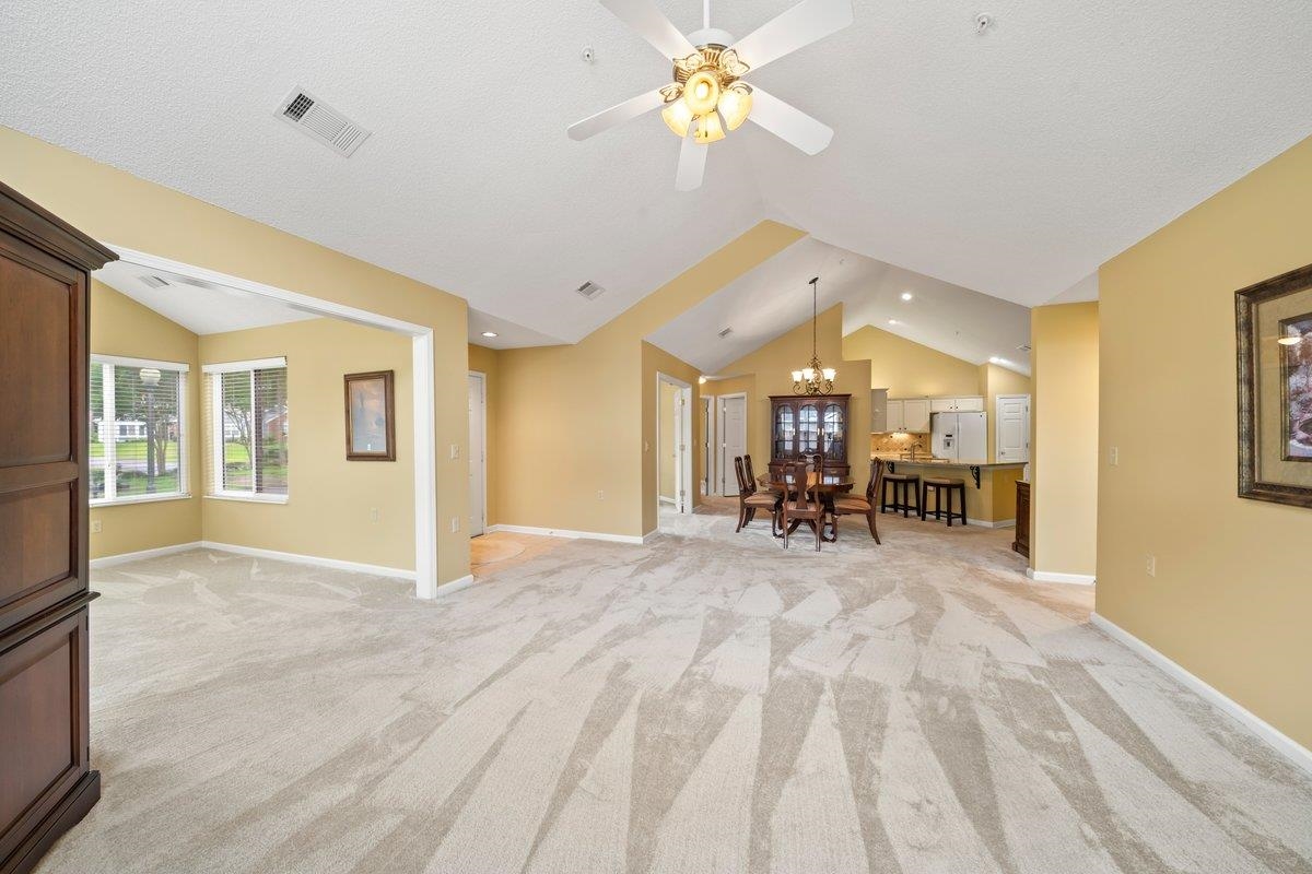 1102 Oak Heights Lane, Unit 93 Collierville, TN 38017 - Photo 9 of 30 a view of a livingroom with a flat screen tv wooden floor and a ceiling fan