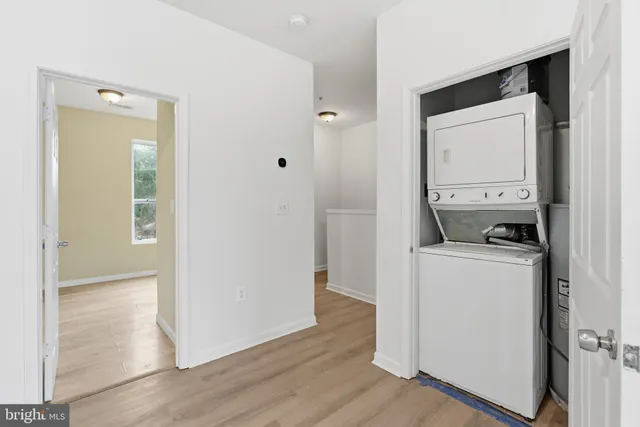 a view of washer and dryer with wooden floor