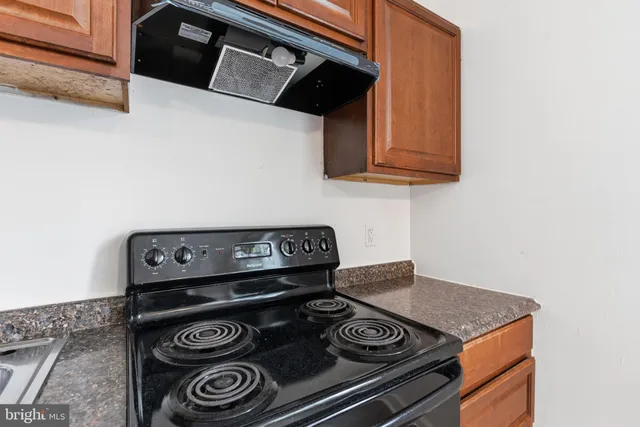 a stove top oven sitting inside of a kitchen