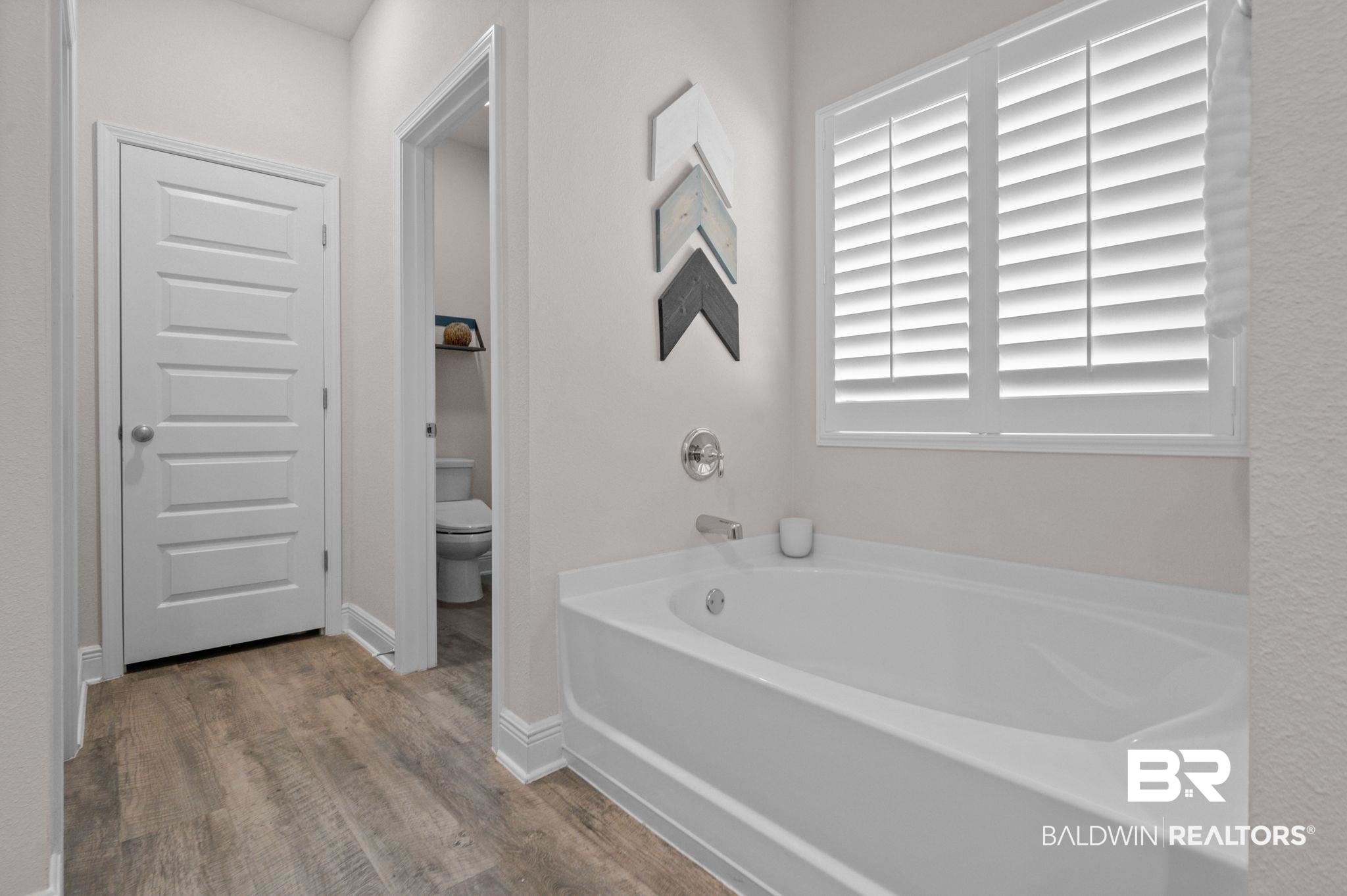 24891 Spectacular Bid Loop Daphne, AL 36526 - Photo 30 of 51 Bathroom with hardwood / wood-style flooring, toilet, and a bathing tub