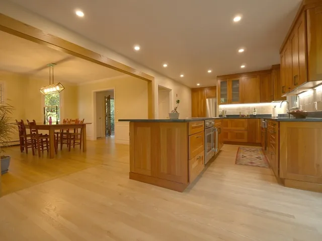 a bathroom with a tub sink and mirror