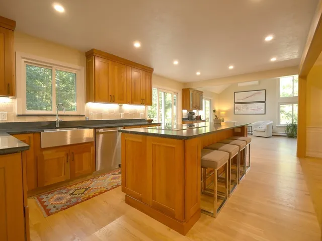 a bathroom with a granite countertop sink a mirror and a bathtub
