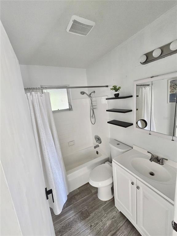 589 Swallow Lane Spring Hill, FL 34606 - Photo 8 of 14 a bathroom with a granite countertop sink toilet and shower