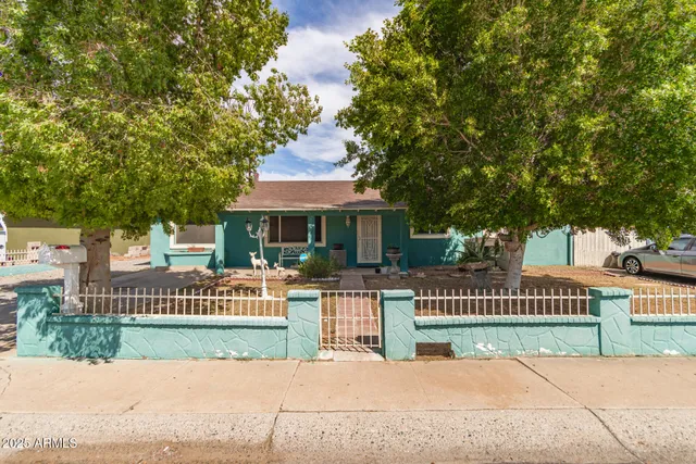 a front view of a house with a garden and plants
