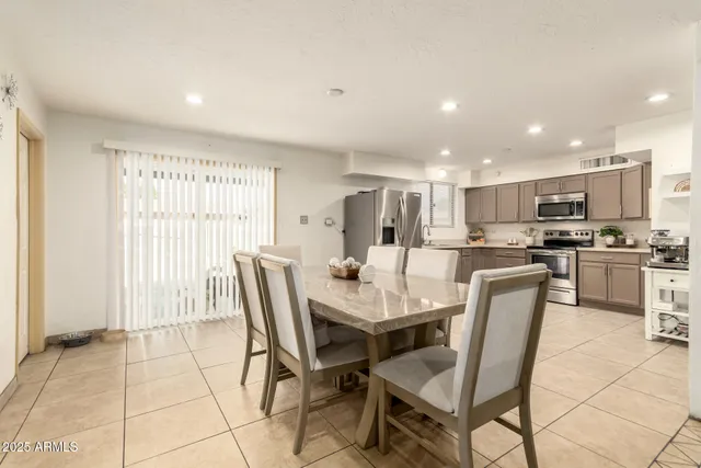 a kitchen with granite countertop a refrigerator and a stove top oven