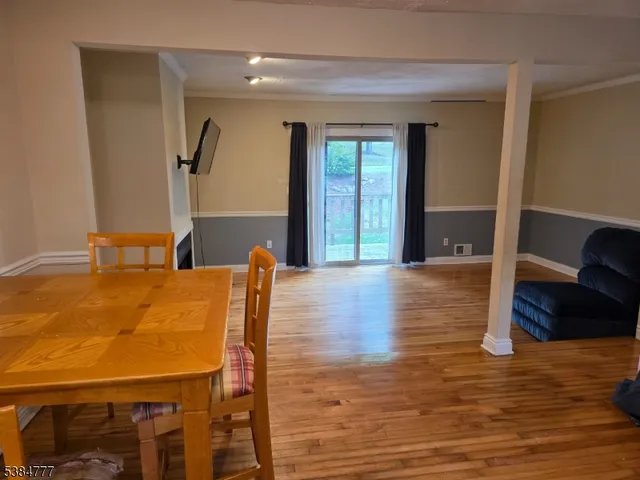 a view of a dining room with furniture and wooden floor