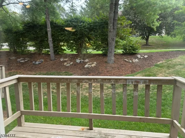 a view of a wooden deck and a yard