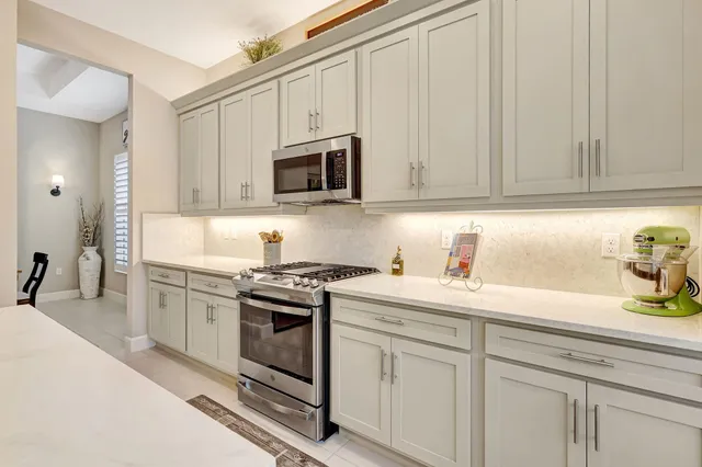 a bedroom with a bed a couch and a flat screen tv